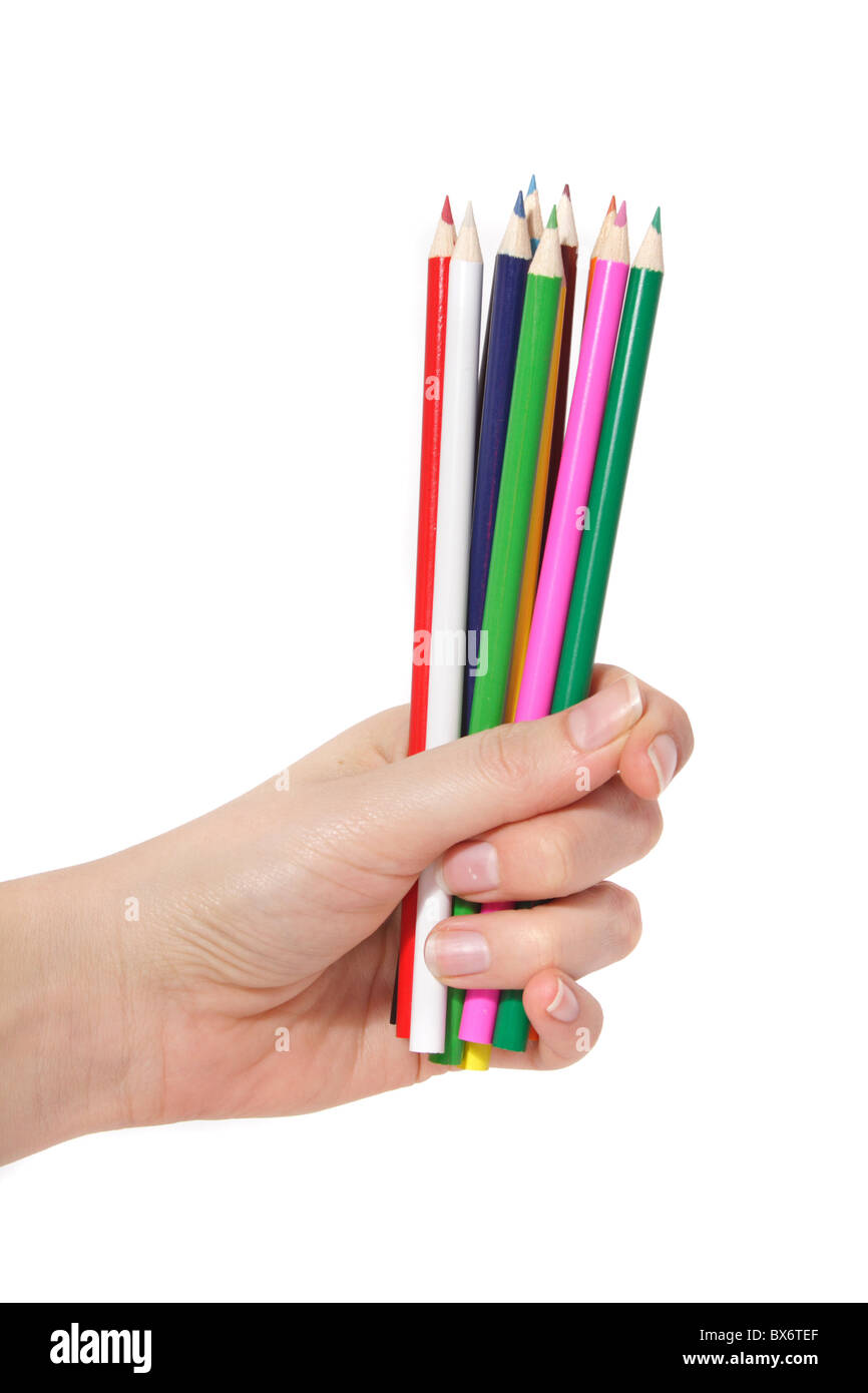 A human hand holding a bunch of colorful crayons. Stock Photo