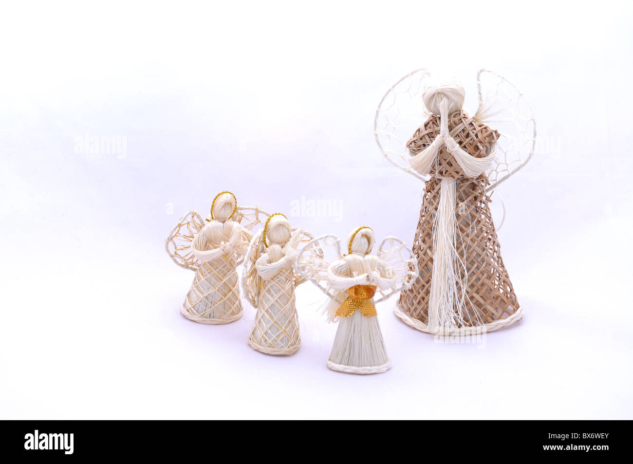 White Christmas straw angels ornament isolated on white background. Stock Photo