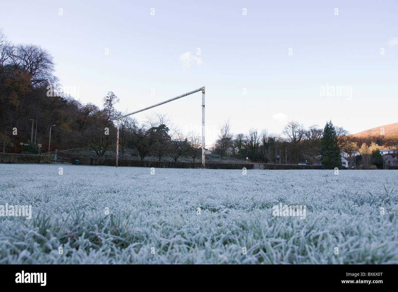 Low landscape view of frozen football pitch and goal posts Stock Photo