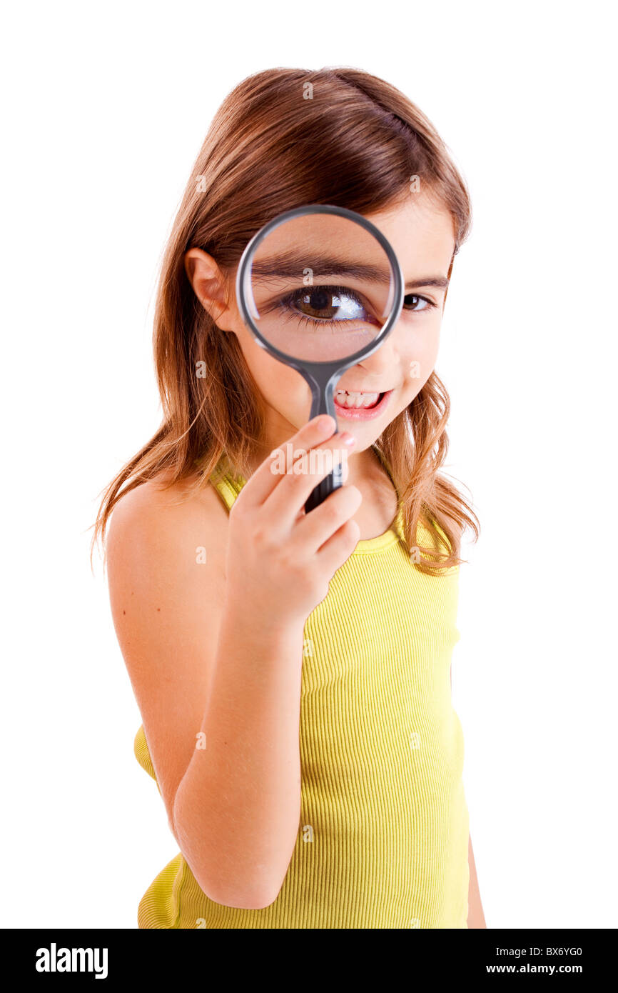 Beautiful little girl looking through a magnifying glass Stock Photo