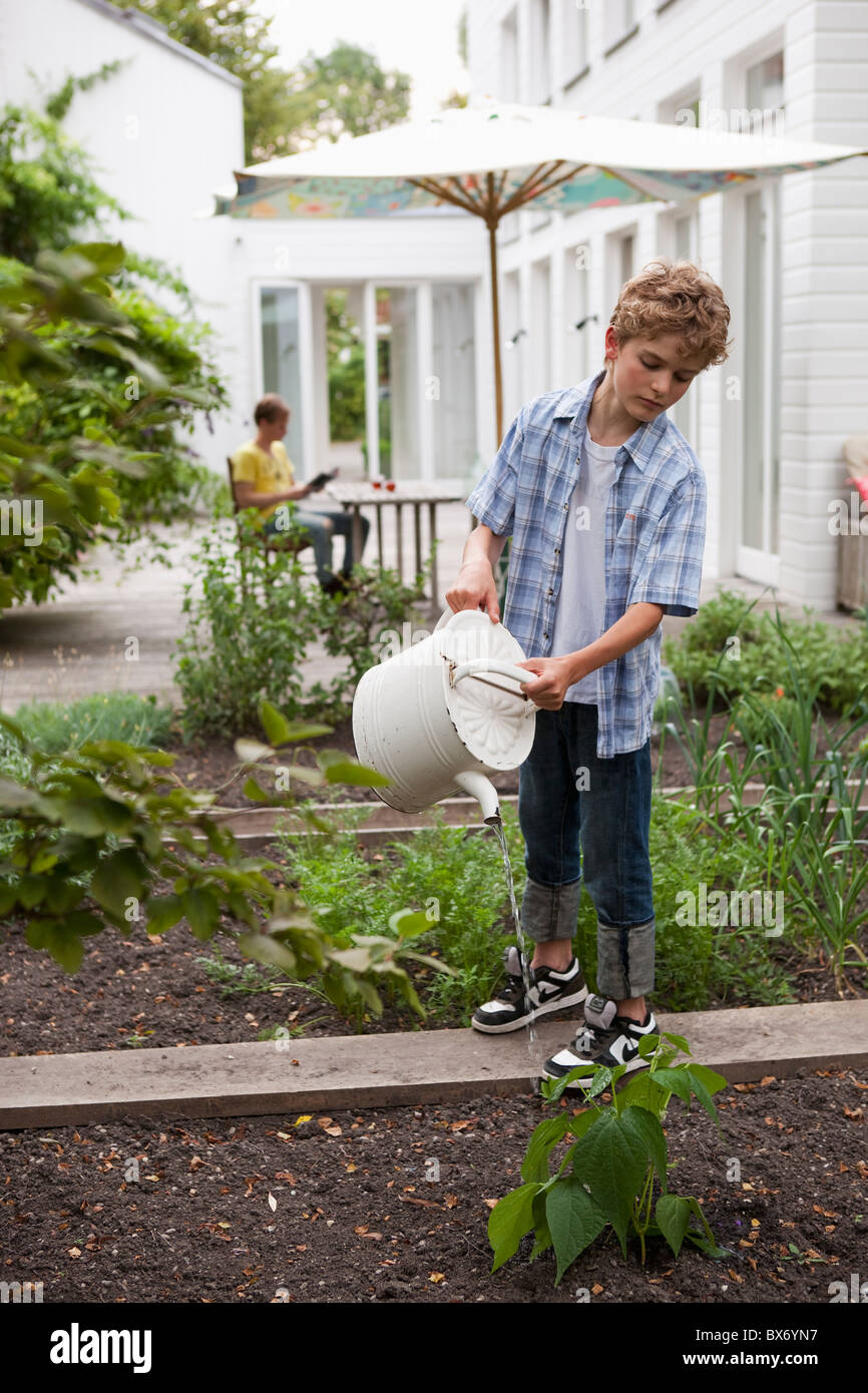 Boy watering plants hi-res stock photography and images - Alamy