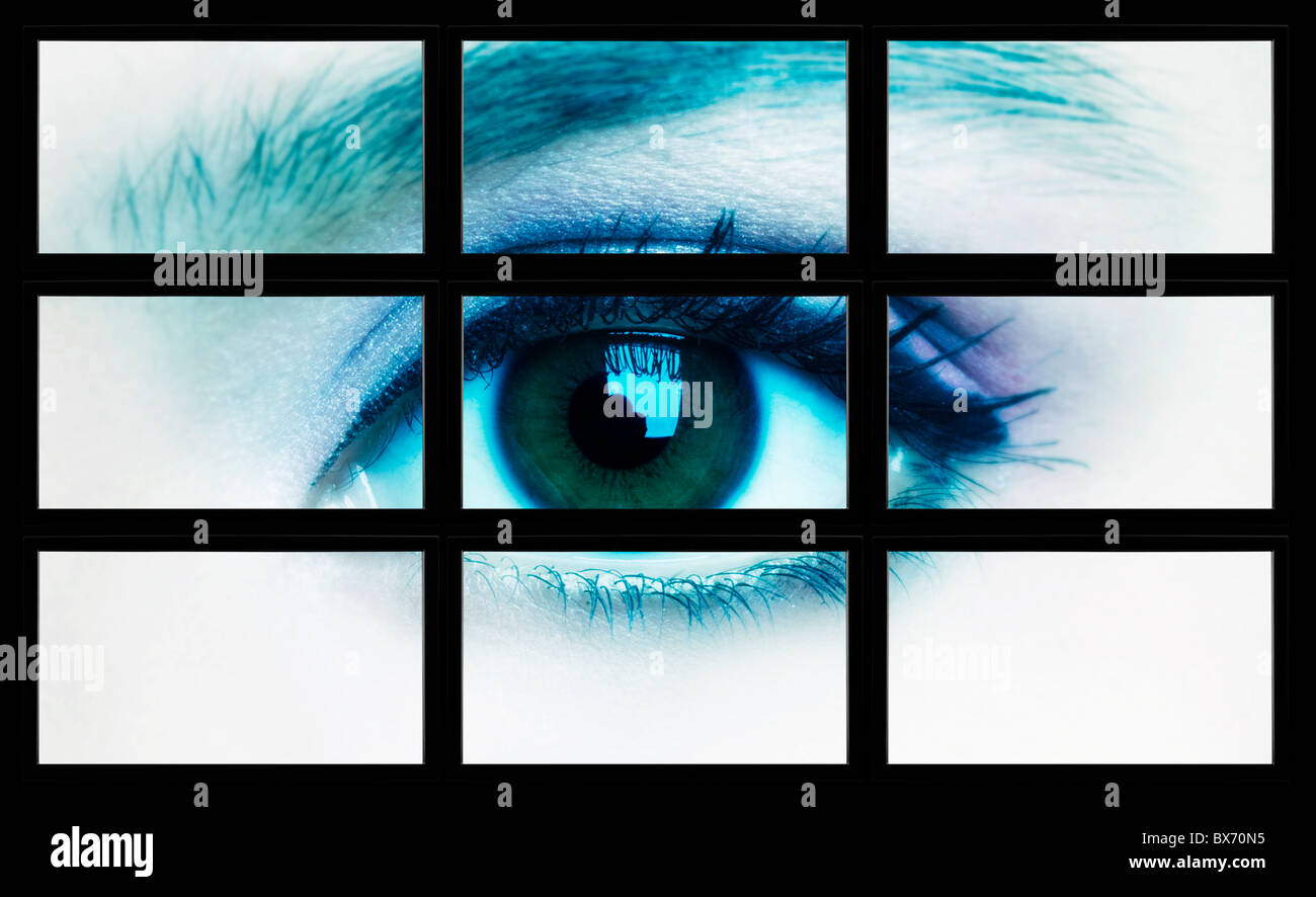Large tv panel compound by a lot of screens displaying a female eye Stock Photo