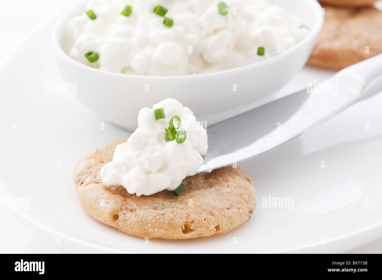 Cottage Cheese On A Cracker As Closeup On White Background Stock