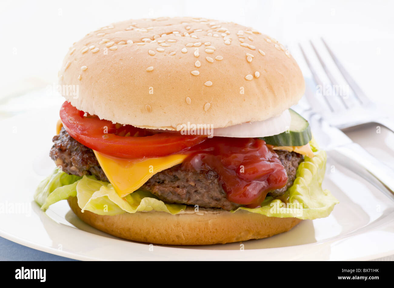 American cheeseburger stuffed with beef patty und cheddar as closeup on