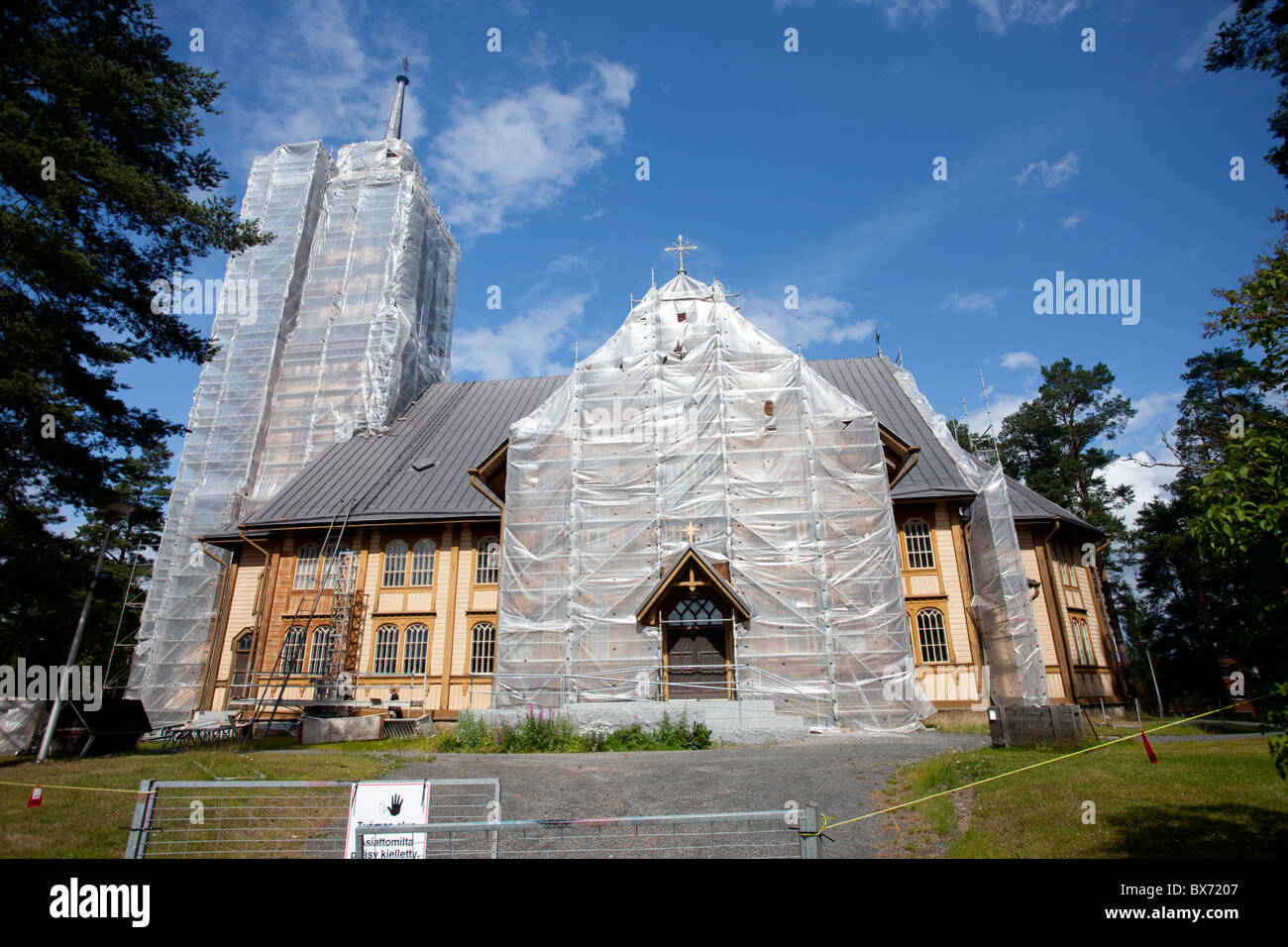 Plastic sheets covering the facade of a wooden Lutheran church at