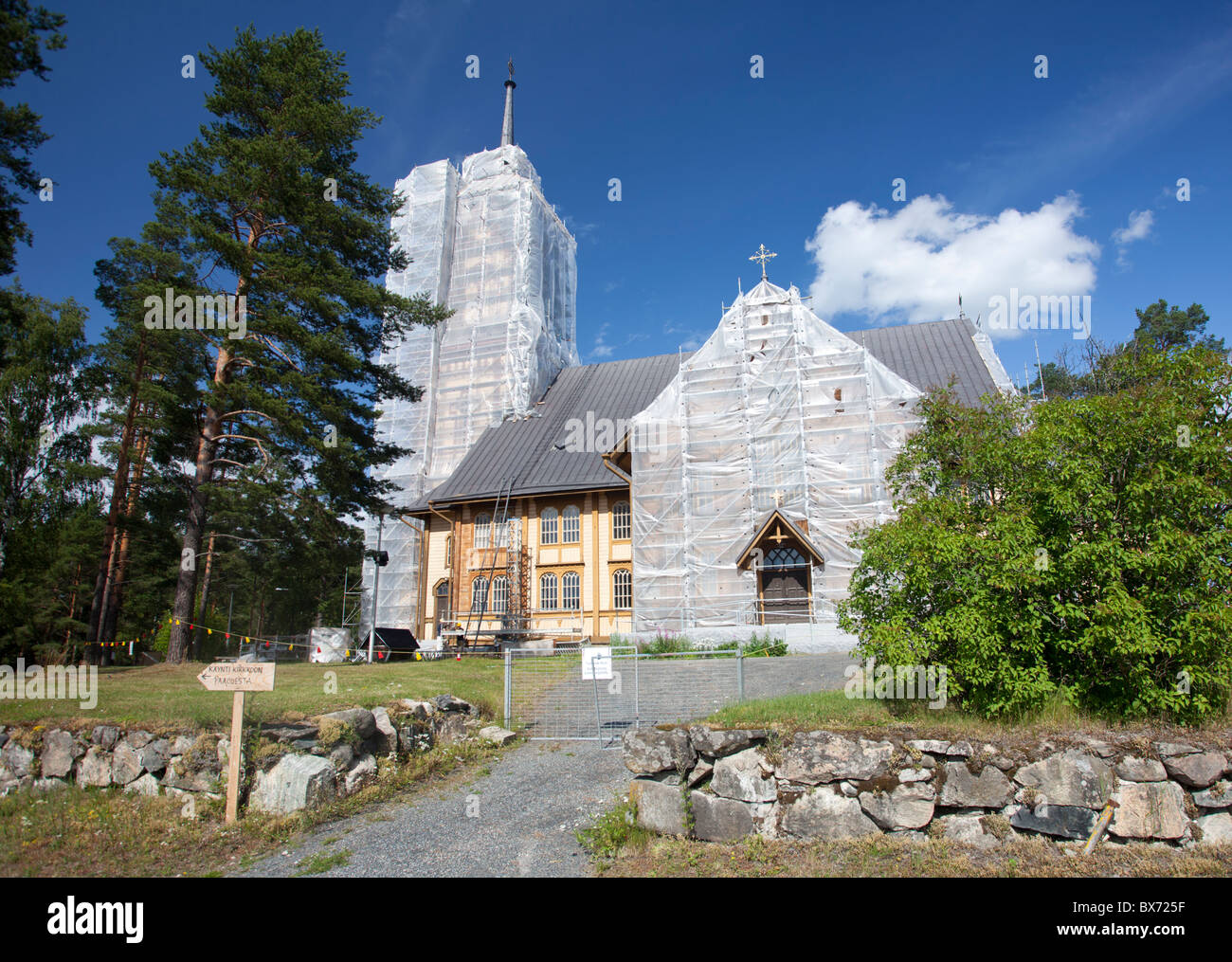 Plastic sheets covering the facade of a wooden Lutheran church at