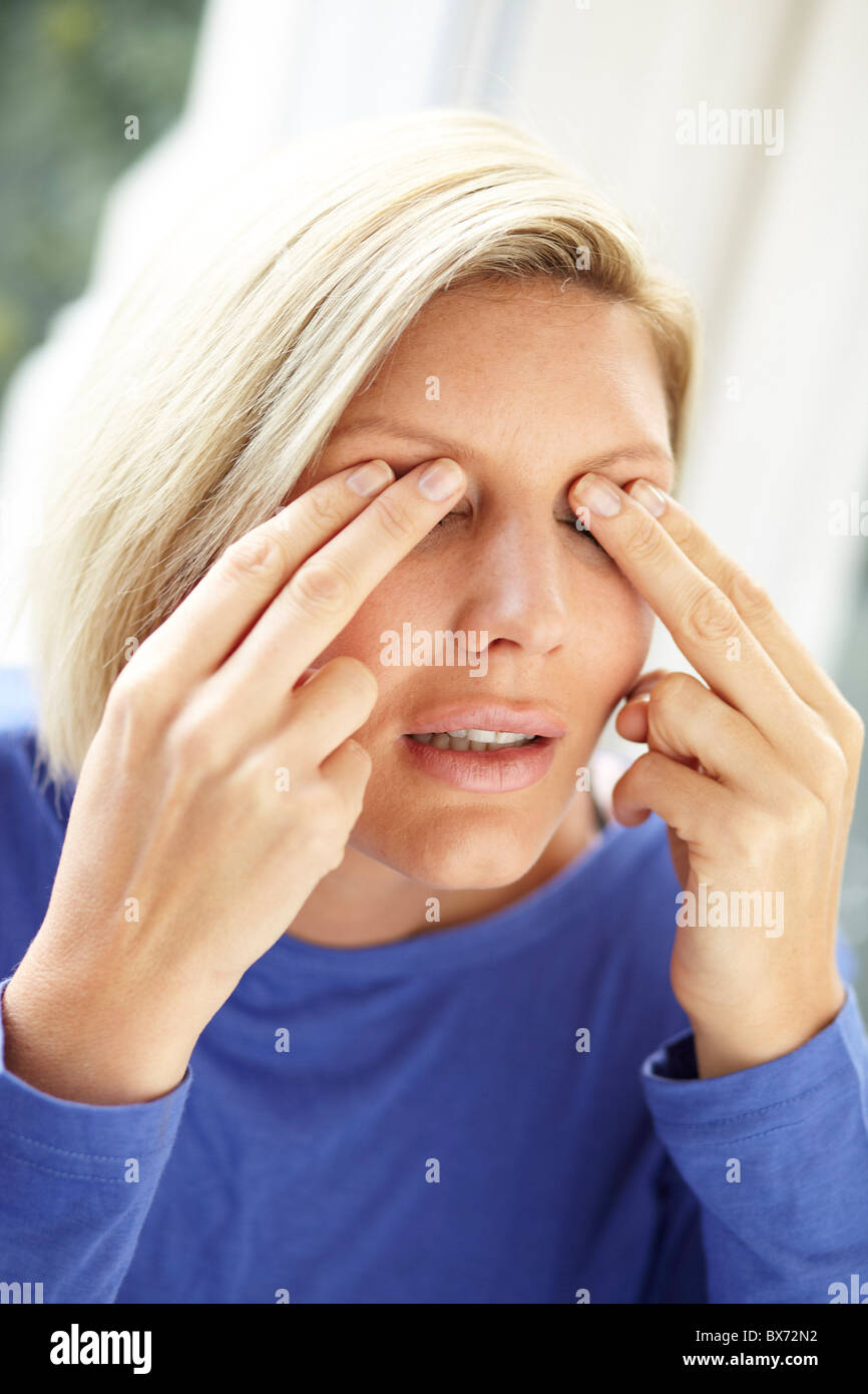 Woman rubbing eyes Stock Photo