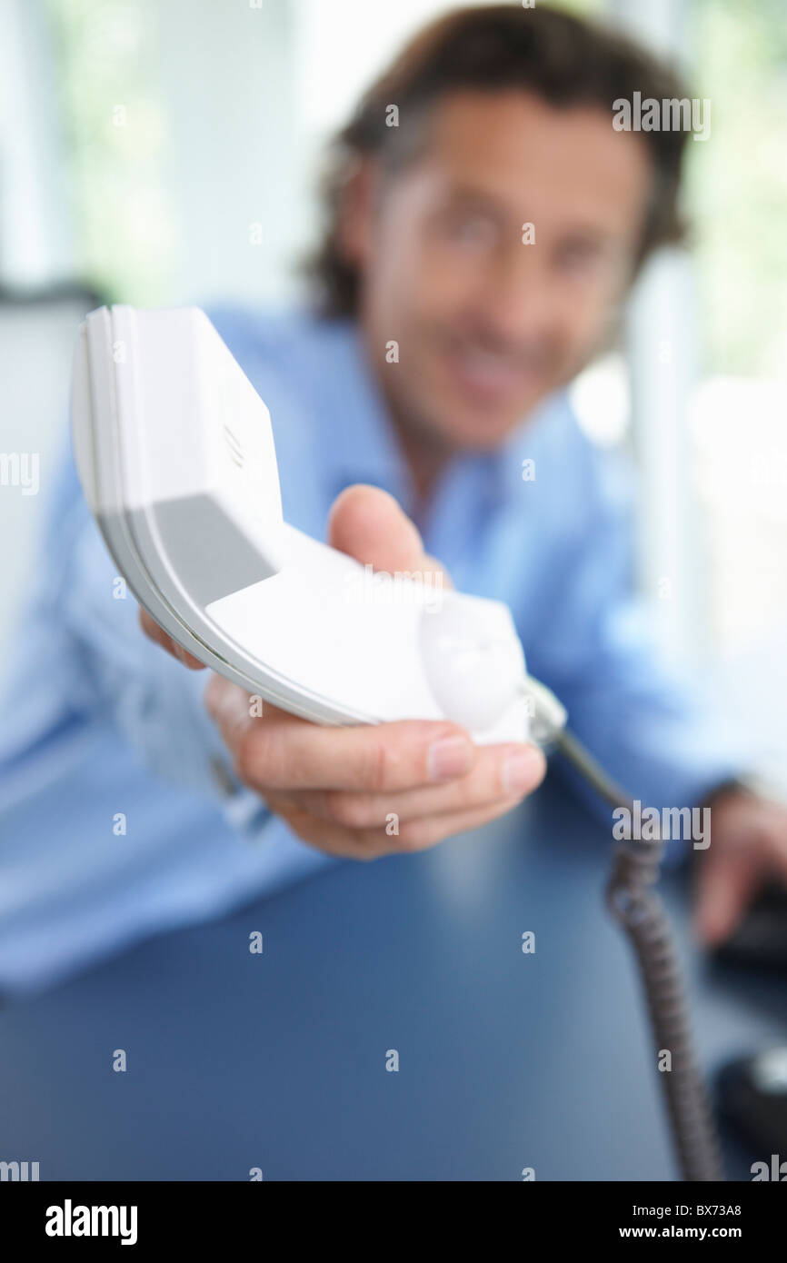 Man passing the phone, close up on horn Stock Photo