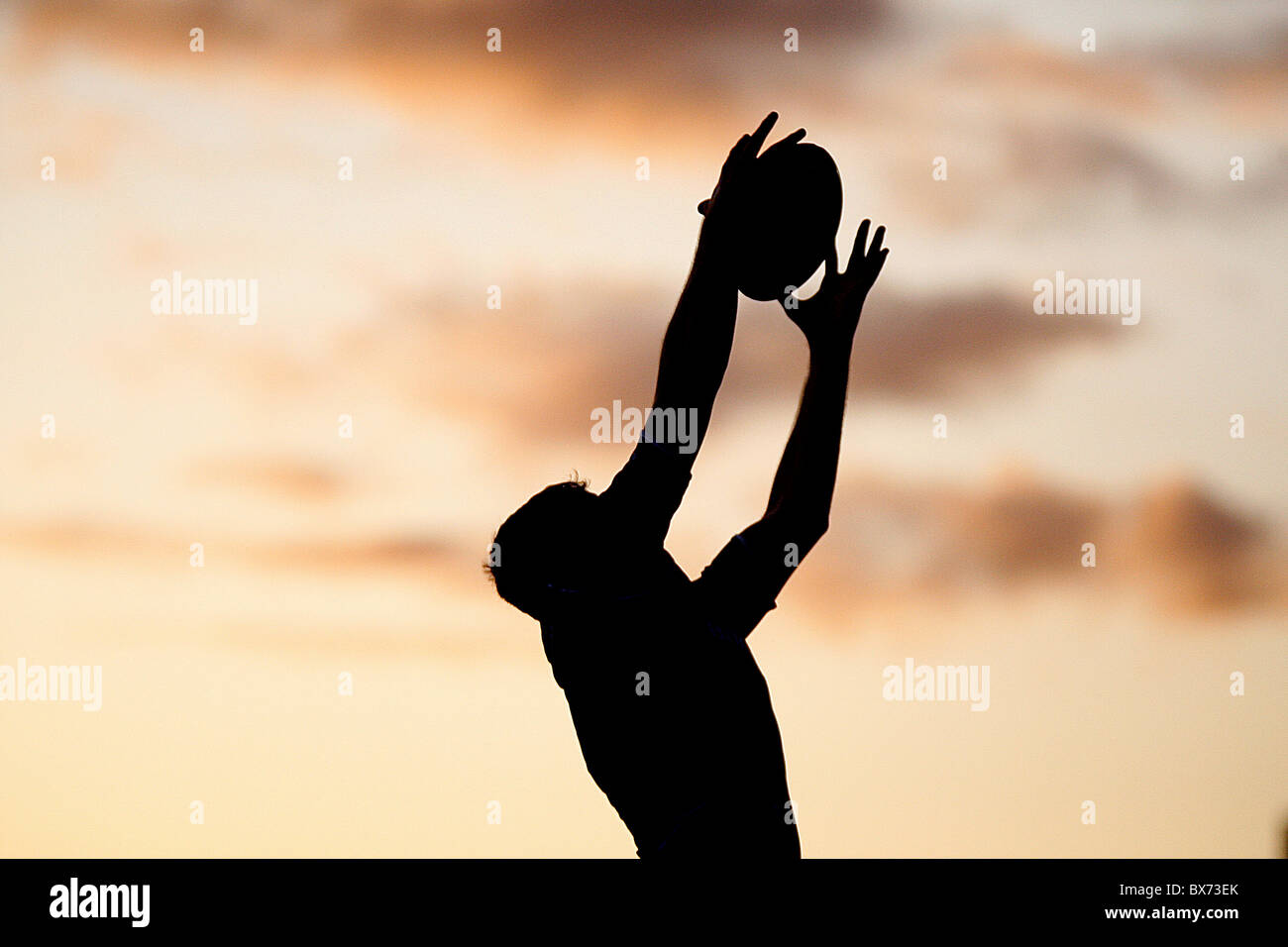 Rugby silhouette player with ball with Sun Set Stock Photo