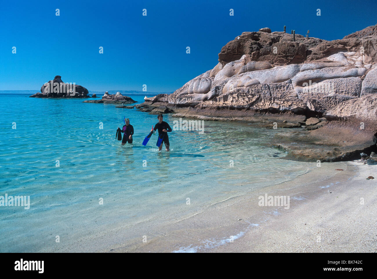 Couple snorkeling on kayaking tour at Espiritu Santo Island in the Sea