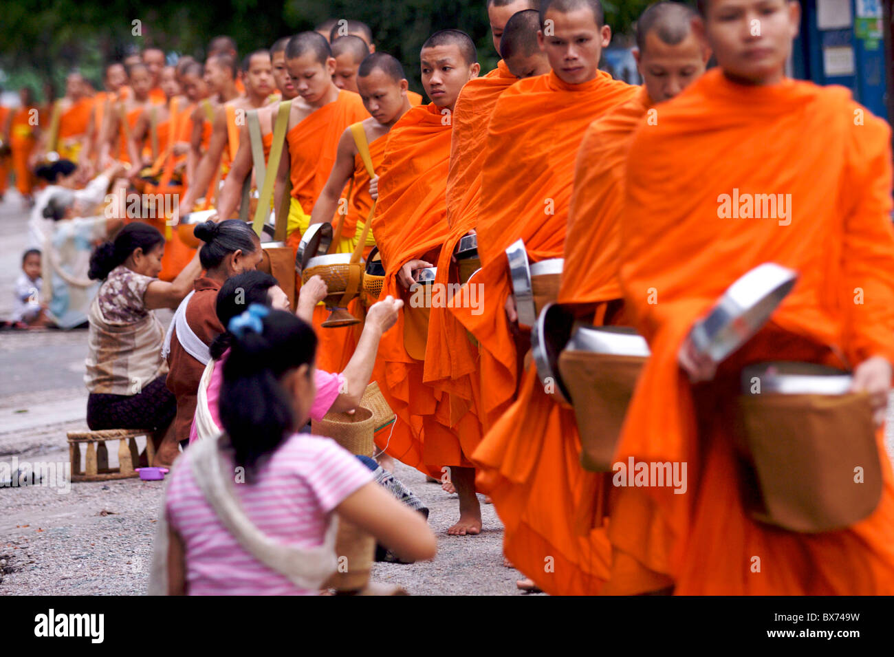 Monks processing at dawn for alms of rice in Luang Prabang, Laos, Indochina, Southeast Asia, Asia Stock Photo