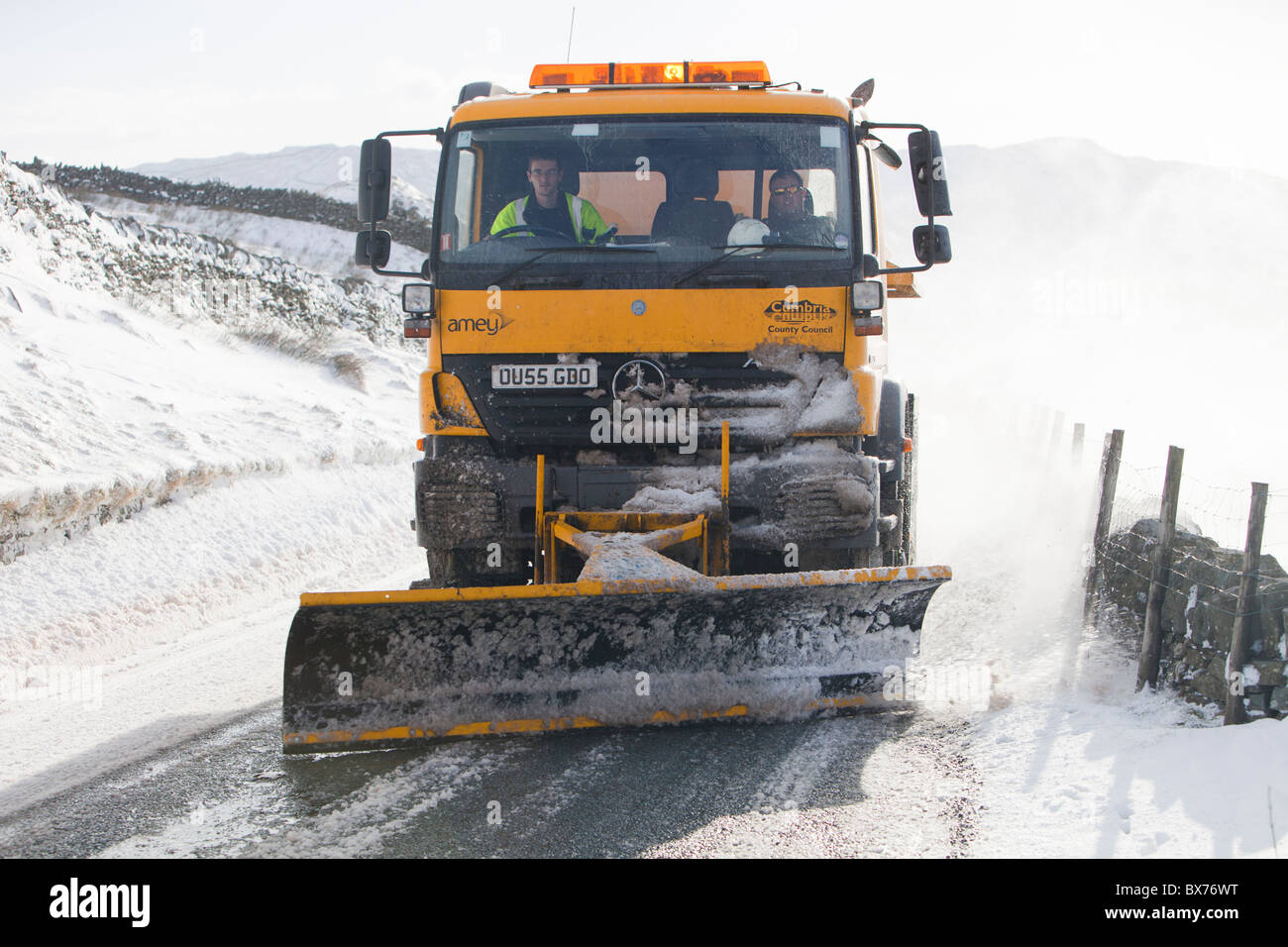 A council snow plough salting and trying to clear Kirkstone Pass in severe winter weather, November 2010, in the Lake District, Stock Photo