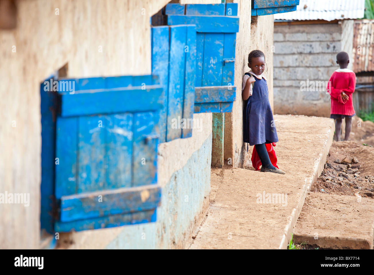 Little girl outside her school in the Kibera slums, Nairobi, Kenya Stock Photo