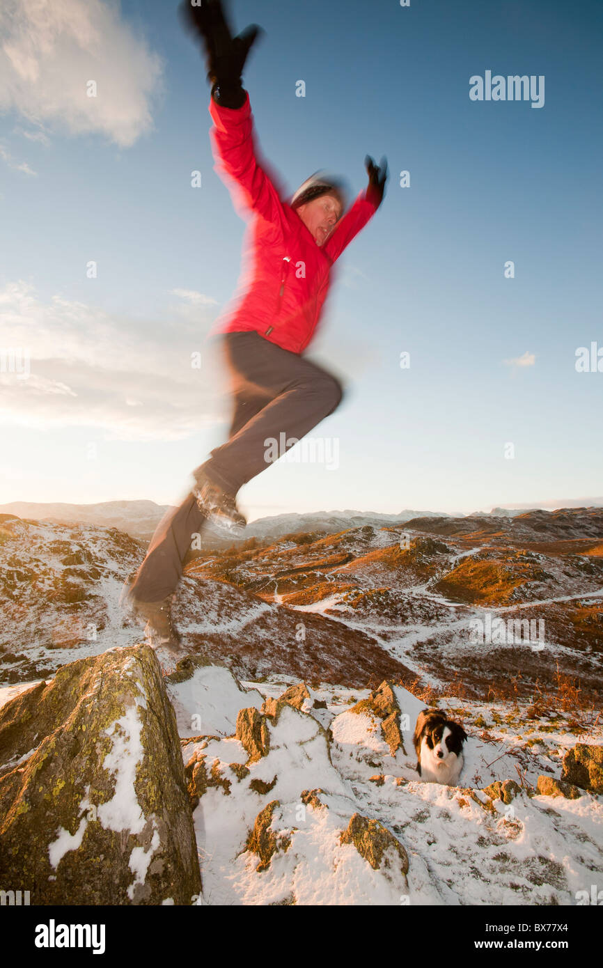 A mountaineer on Todd Crag summit in the Lake District, UK, at dusk. Stock Photo