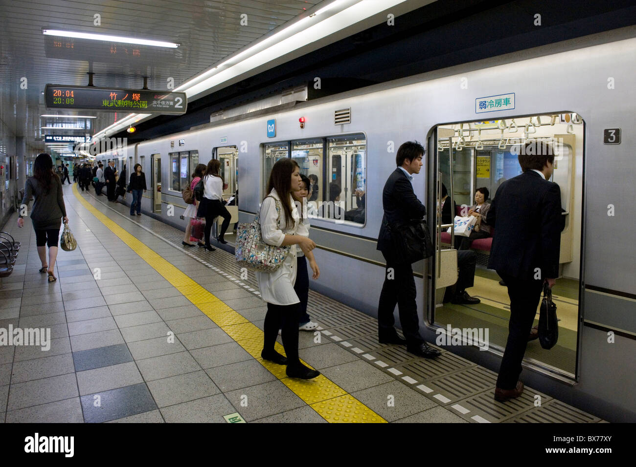 Passengers boarding Tokyo's Hibiya subway line, Tokyo, Japan, Asia Stock Photo