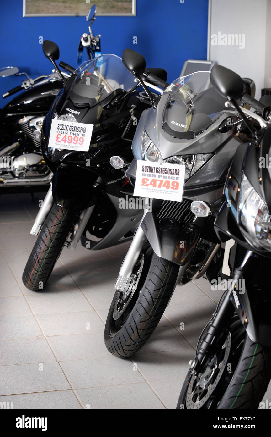 Suzuki motorbikes on sale in a showroom UK Stock Photo