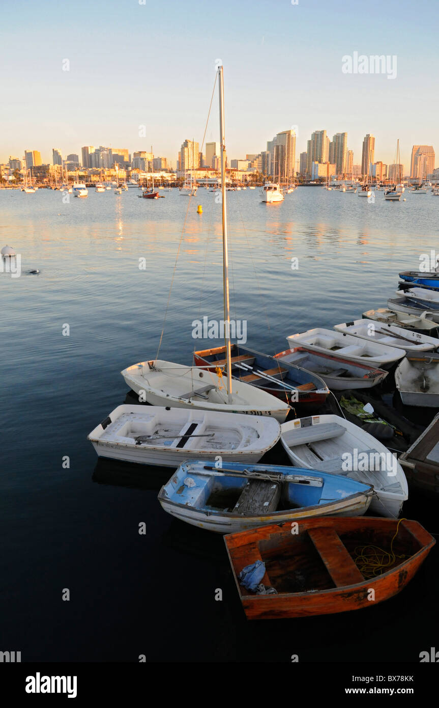 San Diego yacht harbor and bay with boats moored and anchored below city skyline at sunset Stock Photo