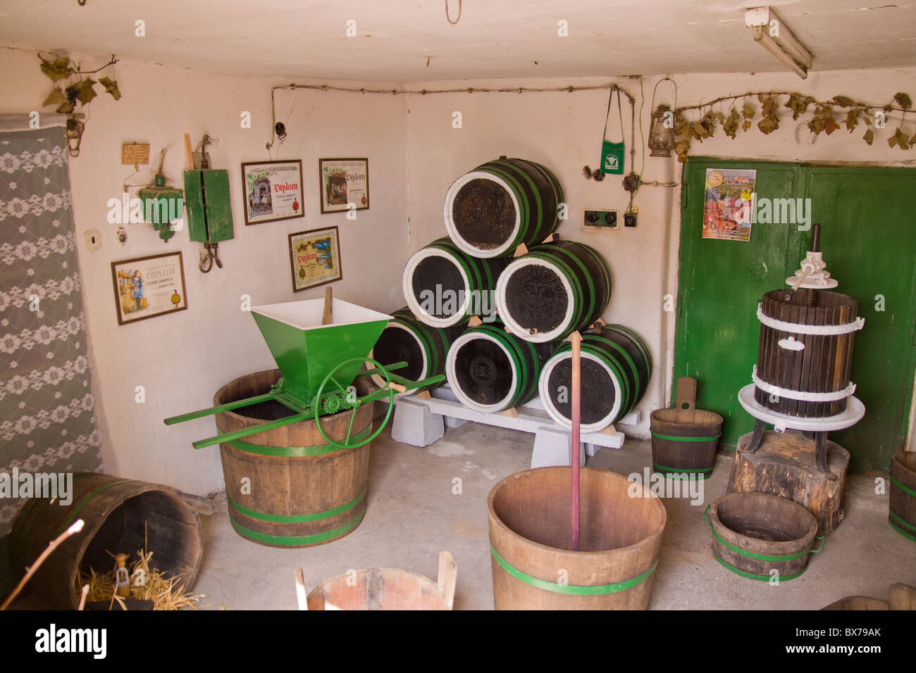 interrior of an old fashioned wine cave with barrels and tools for wine