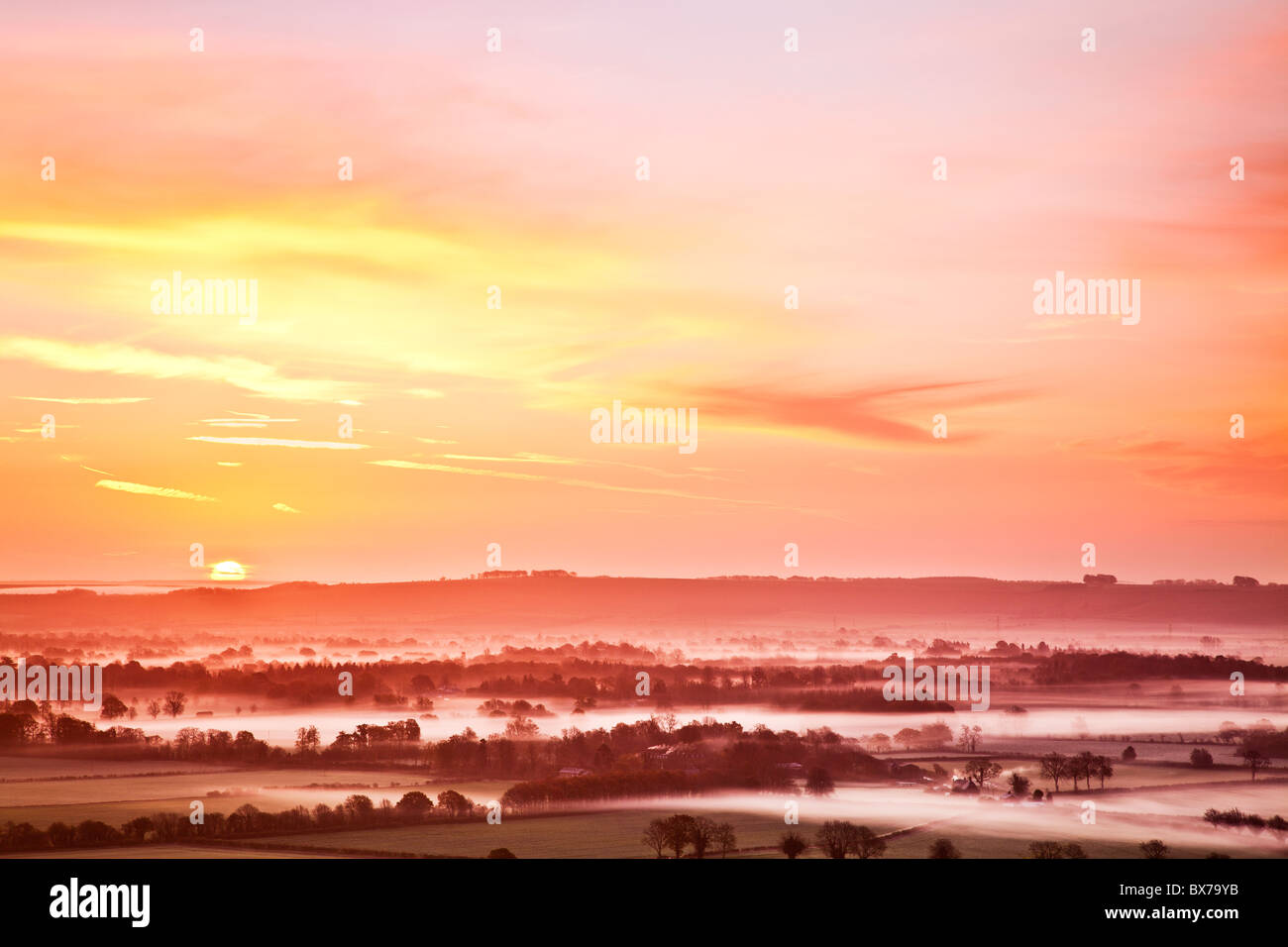 Misty autumn sunrise from Knapp Hill over the Vale of Pewsey in Wiltshire, England, UK Stock Photo