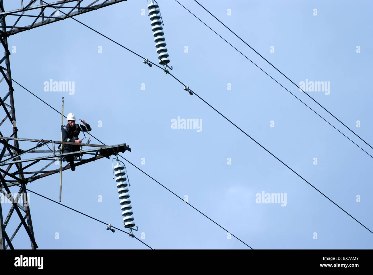 Man Working on Electricity Pylon Stock Photo
