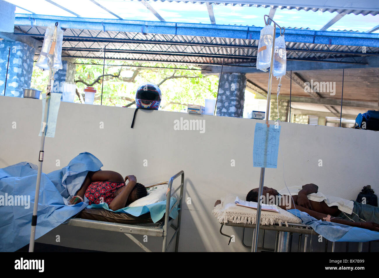 Cholera patients lie on gurneys where they receive hydration through an I.V. Stock Photo