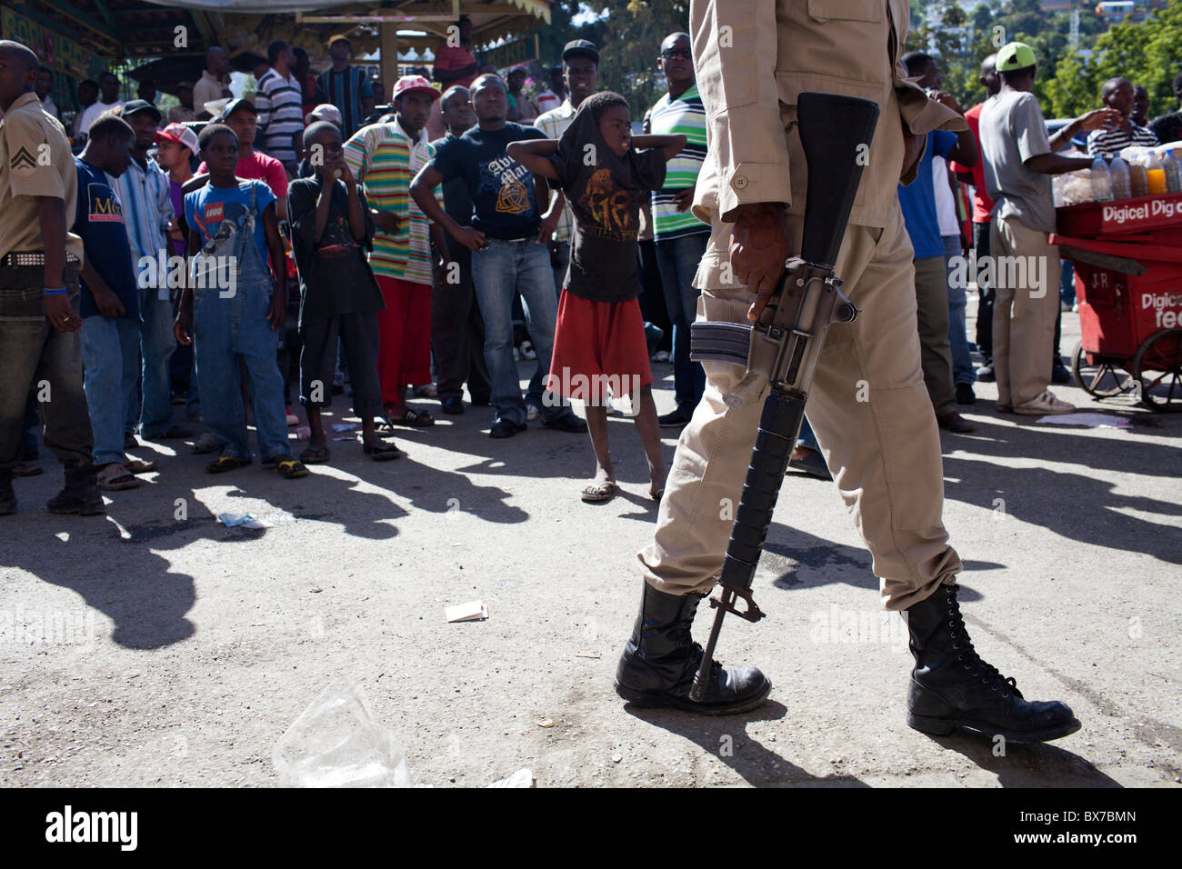 A police officer keeps a crowd back from a polling station during presidential and legislative elections Stock Photo