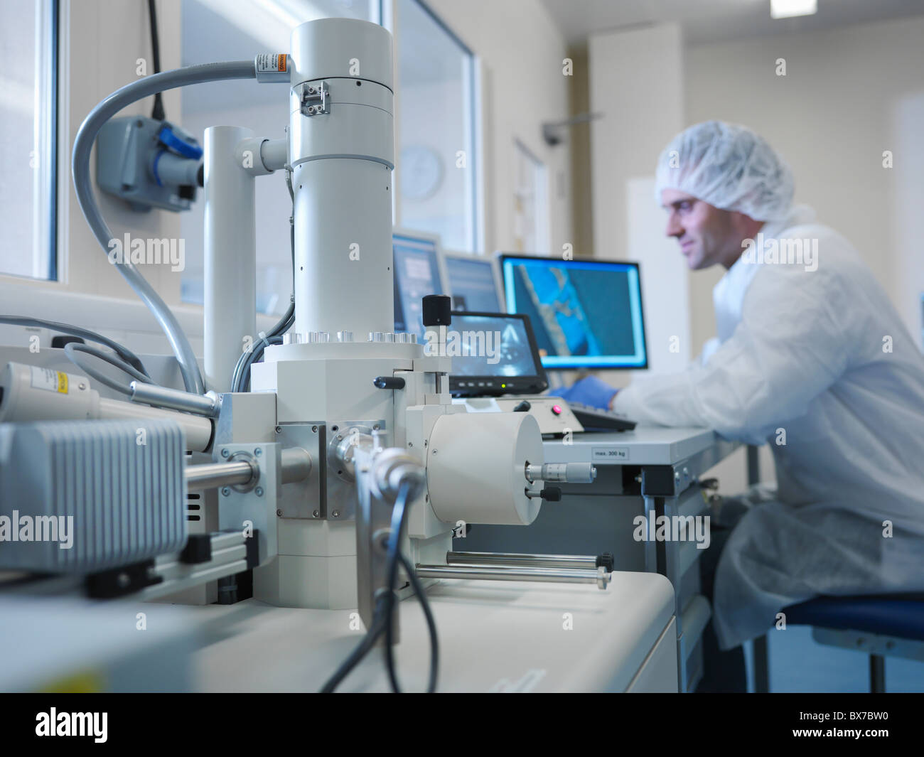 Scientist with electron microscope Stock Photo