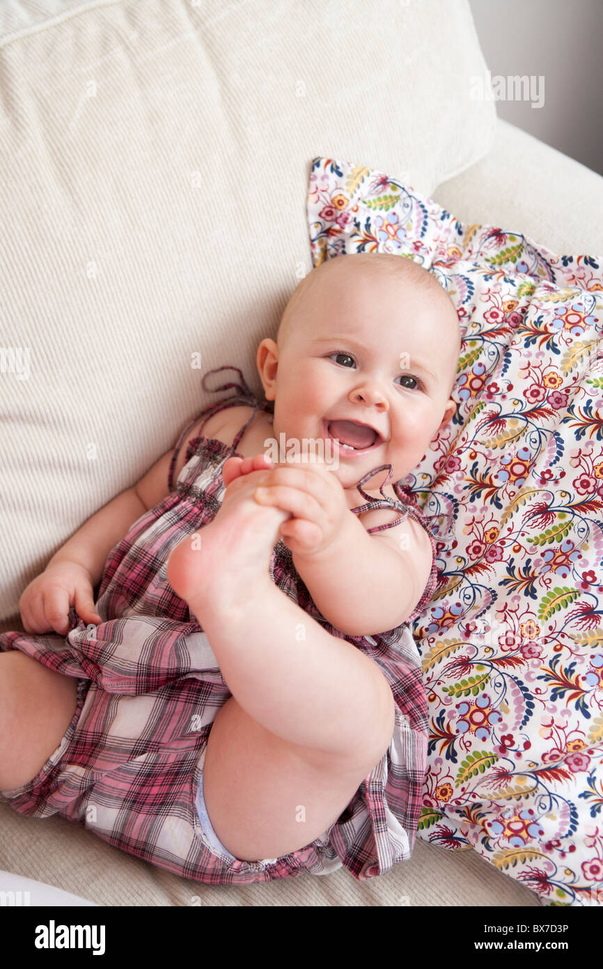 Baby laying on couch Stock Photo Alamy