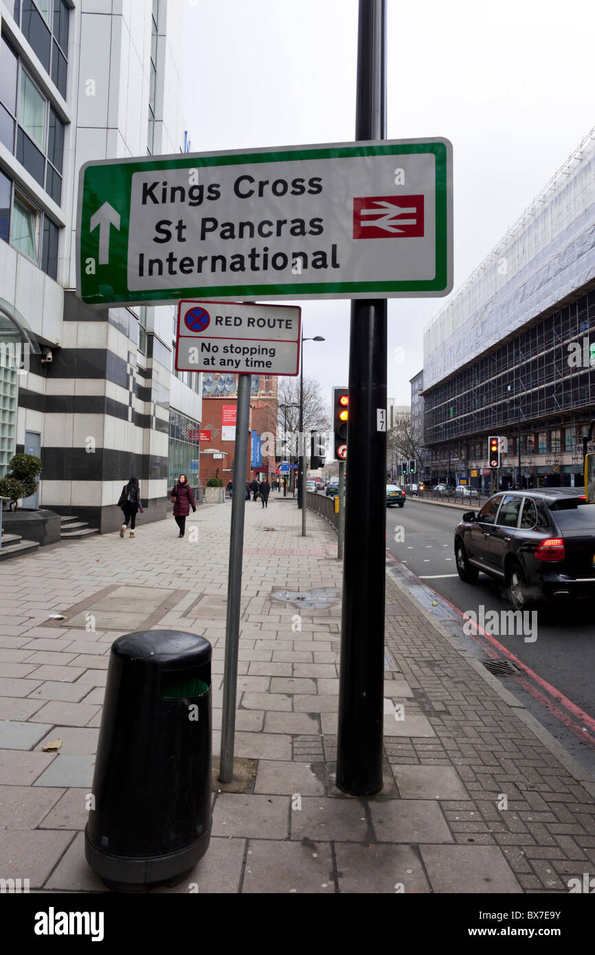 Sign for Kings Cross & St Pancras International railway stations & a red route, no stopping sign