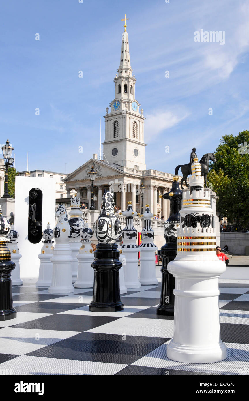 Large ceramic chess pieces part of the London Design Festival in Trafalgar Square 2009 with spire of St Martin in the Fields church beyond Stock Photo