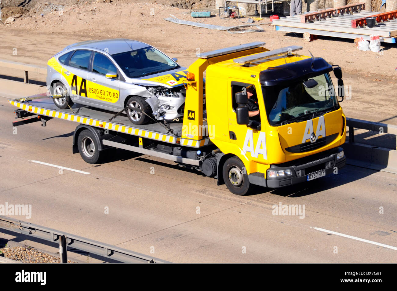 AA breakdown truck loaded with damaged AA learner drivers instruction car Stock Photo