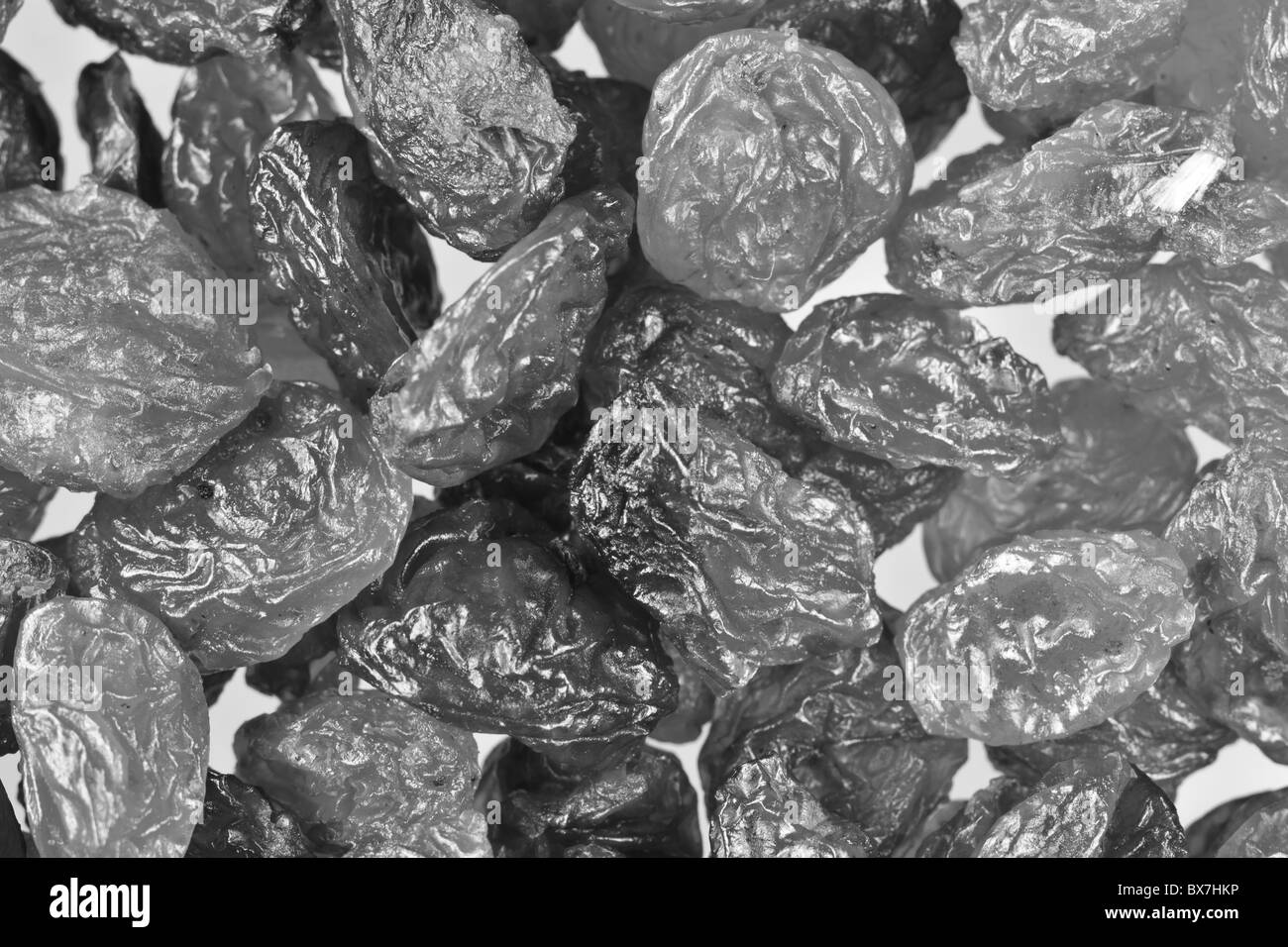 Black and white background of raisins, extreme close up. Stock Photo