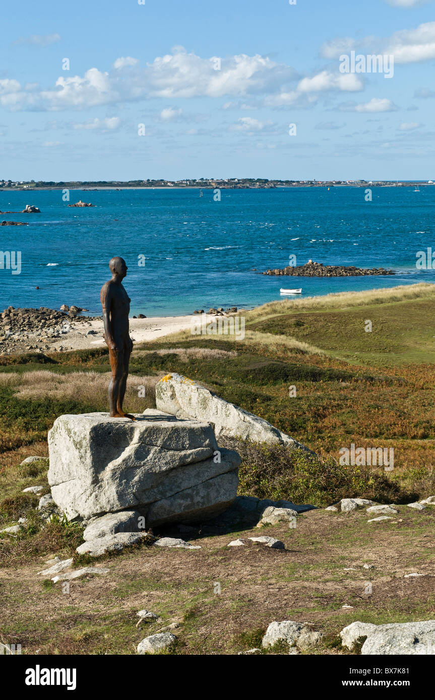 dh Herm Island HERM GUERNSEY Antony Gormley statue on Herm cast iron figure called Another Time modern sculpture outside channel islands Stock Photo