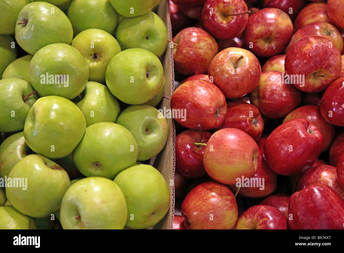 A market stall offering green and red apples. Stock Photo