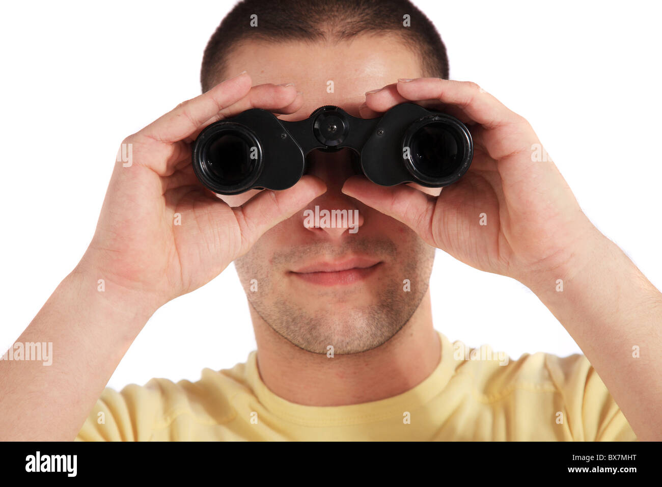 Attractive young man using spyglass. All on white background Stock Photo