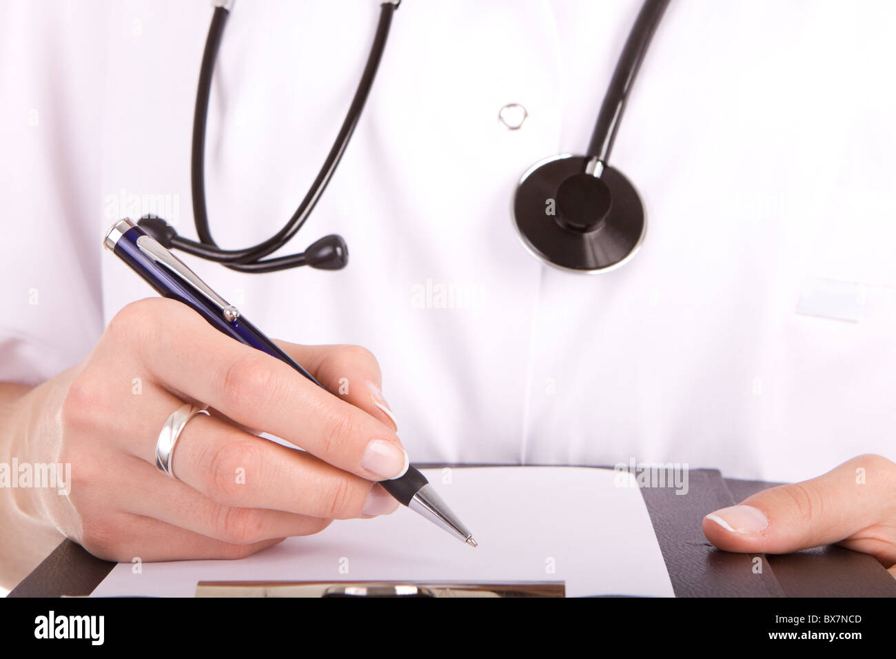 Healthcare professional doctor or nurse writing with a fountain pen