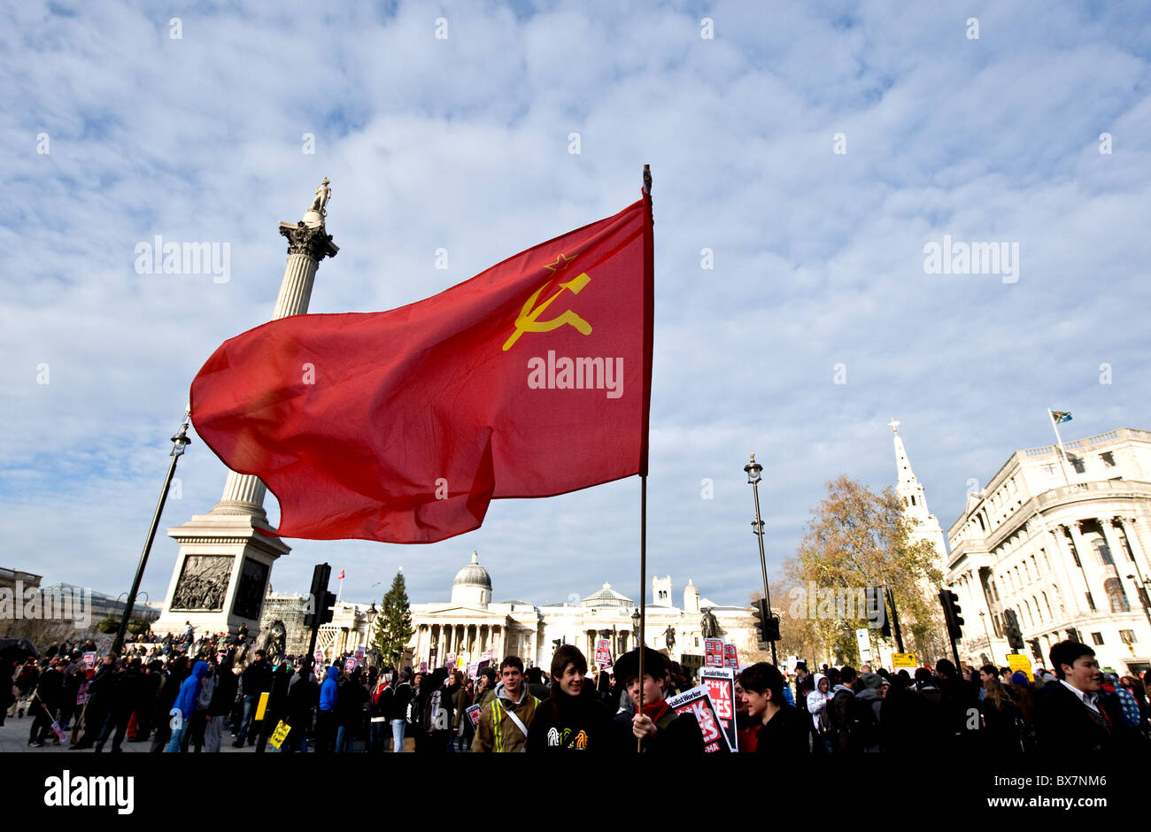 A communist flag held by students at a demonstration in Trafalgar Square in London. Stock Photo