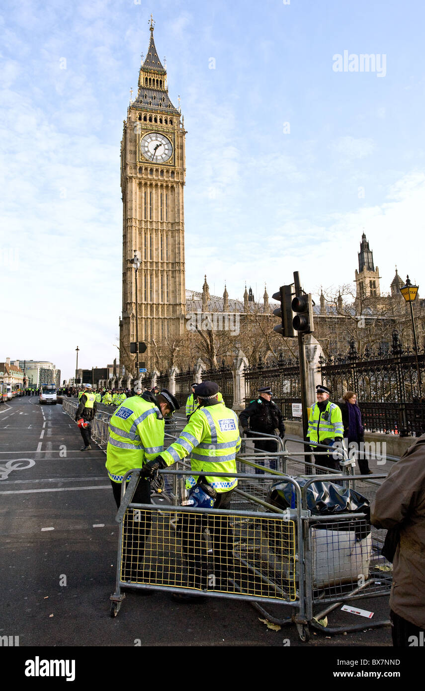 Metropolitan Police officers setting up a security barrier outside the Houses of Parliament in London. Stock Photo