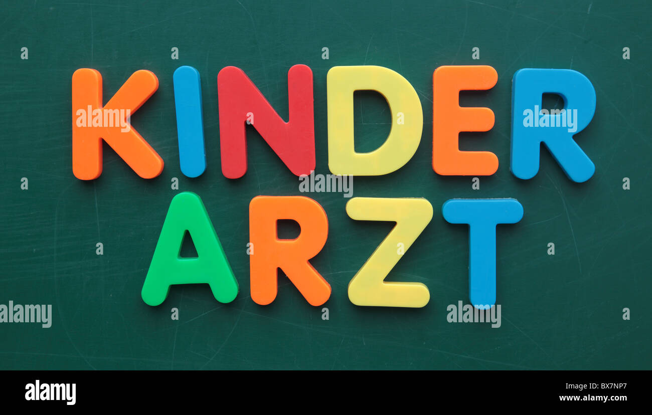 German term for pediatrician in colorful letters on a blackboard. Stock Photo
