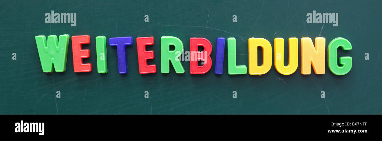 The german term for schooling in colored letters on a blackboard. Stock Photo