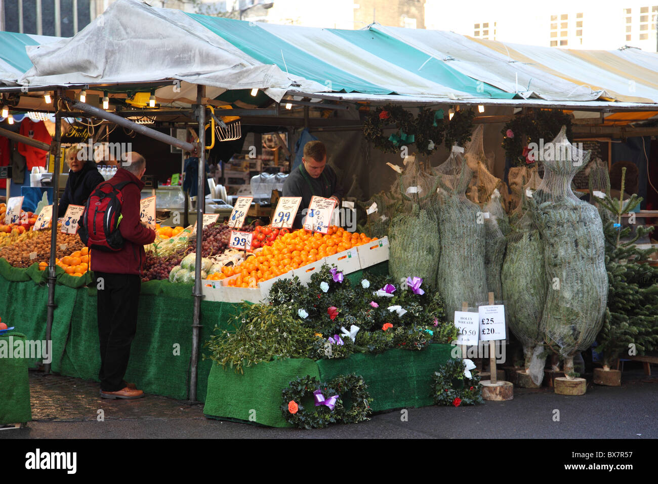 A stall selling fruit, vegetables and Christmas trees on a market in Cambridge, England, U.K. Stock Photo