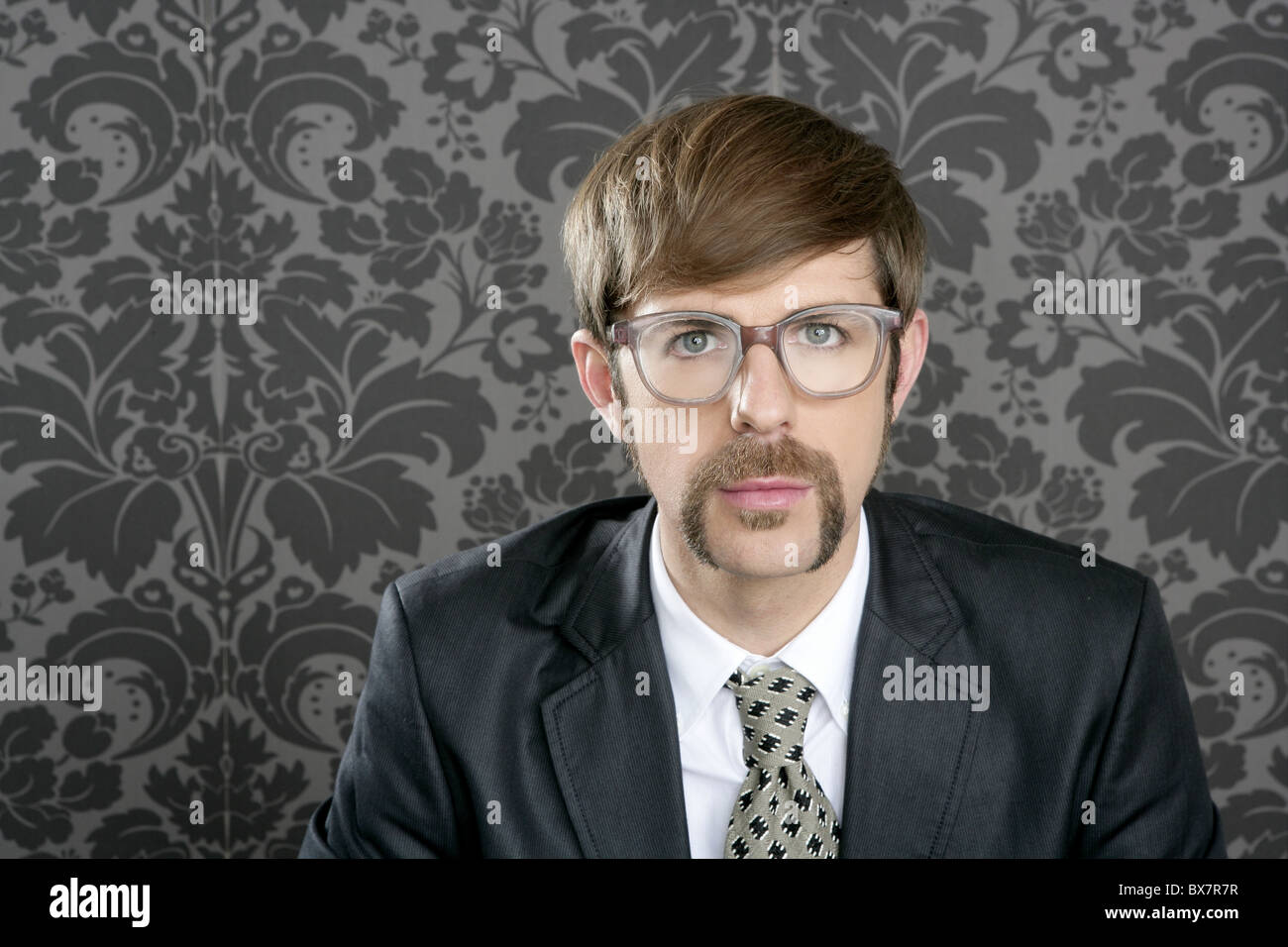 businessman nerd retro glasses geek portrait on vintage wallpaper Stock