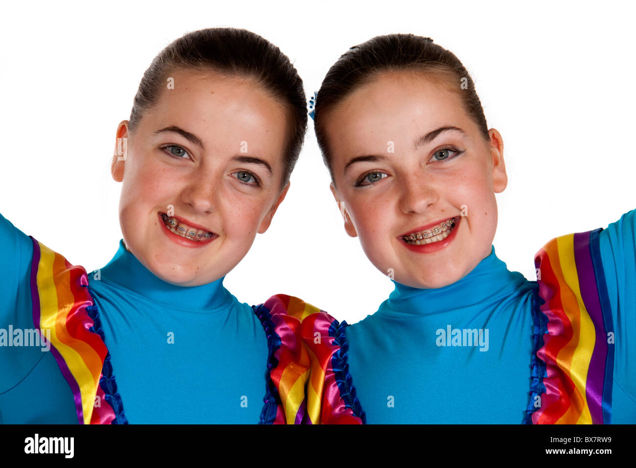 Studio shot of beautiful young identical twins in colourful Mexican national dancing costume Stock Photo