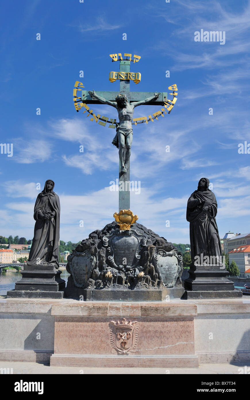 The Crucifix and Calvary, one of several medieval statues on Charles Bridge in Prague, Czech Republic. Stock Photo