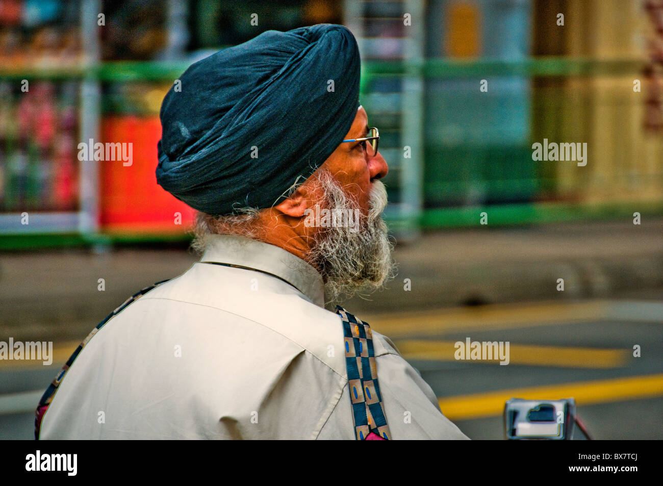 Portrait of Indian man walking across street in Singapore Little India Stock Photo
