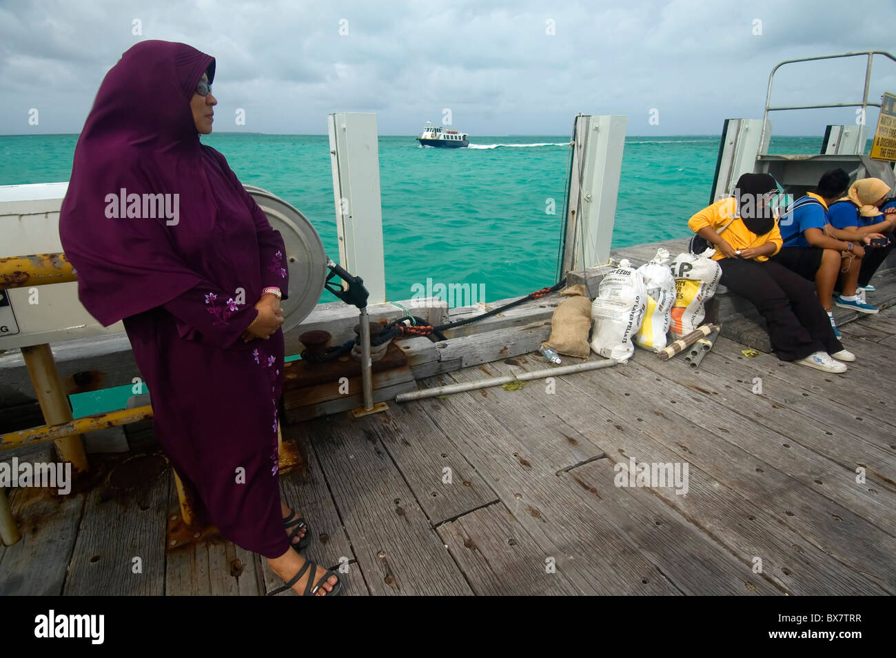Teacher and students waiting for ferry back to Home Island, Cocos
