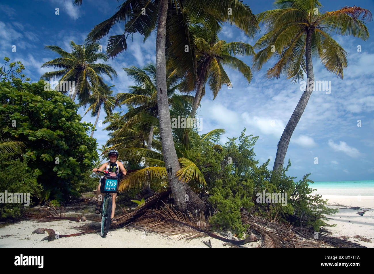 Tourist cycling on sandy paths on West Island, Cocos Keeling, Indian Ocean. No MR or PR Stock Photo