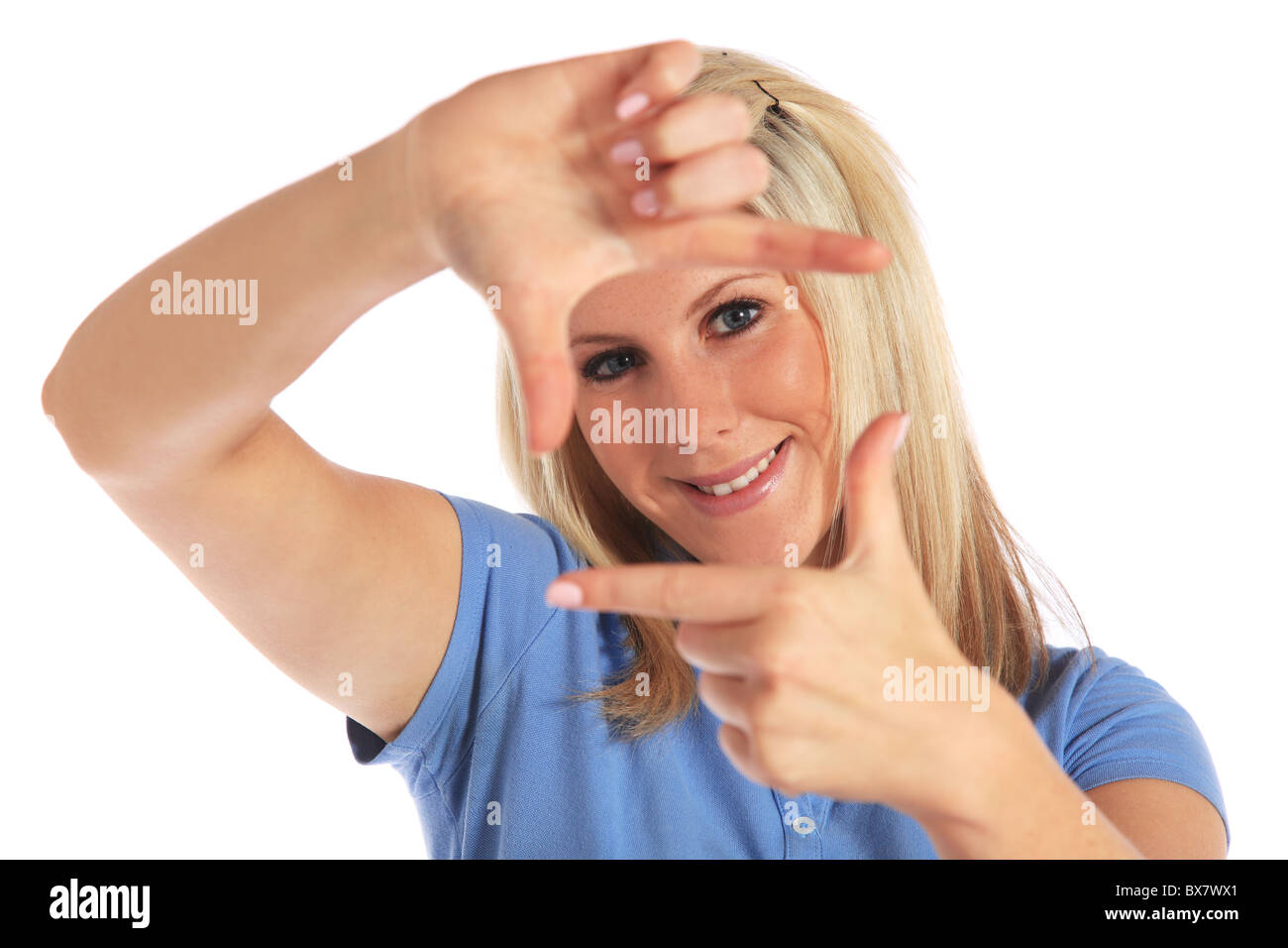 Attractive young woman building a frame out of her hands. All on white background. Stock Photo