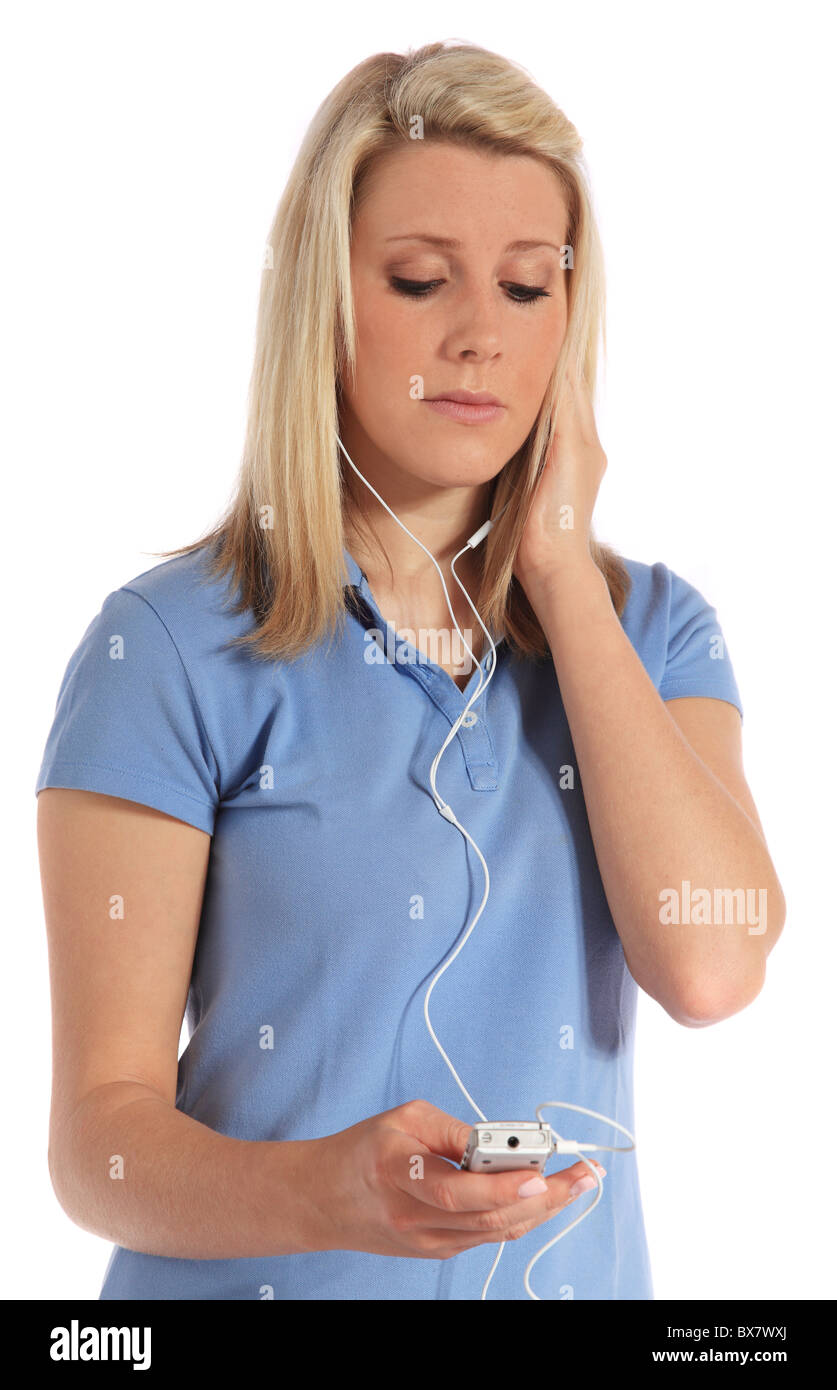 Attractive young woman got earache from listening to loud music through earphones. All on white background. Stock Photo