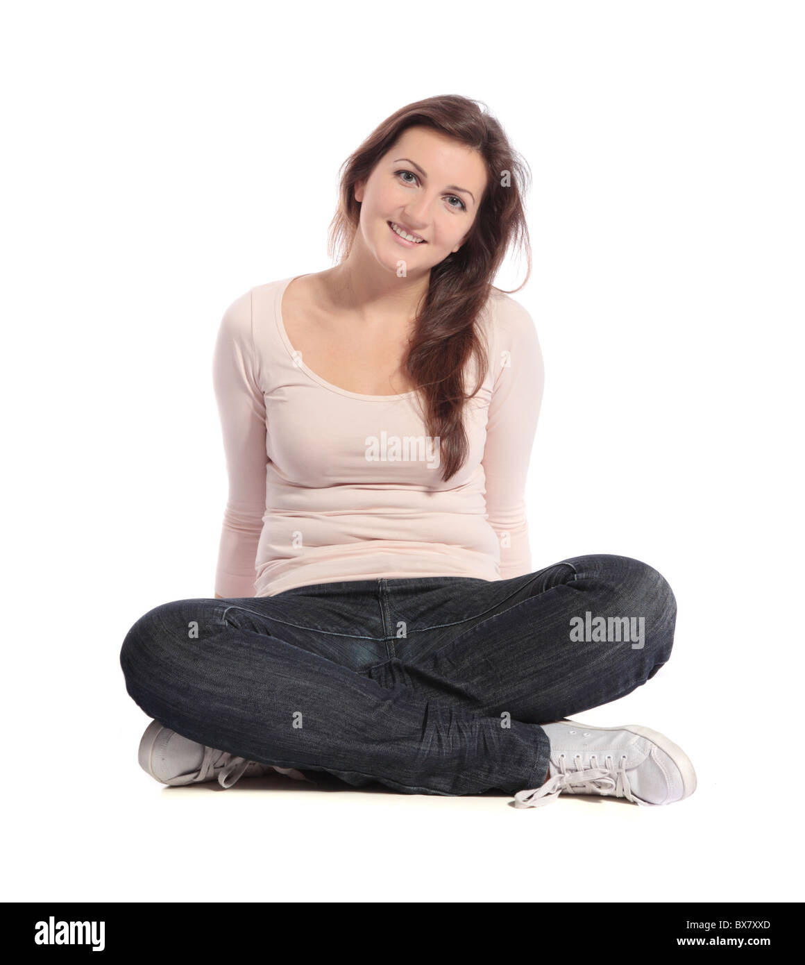 Attractive young woman sitting cross-legged. All isolated on white ...
